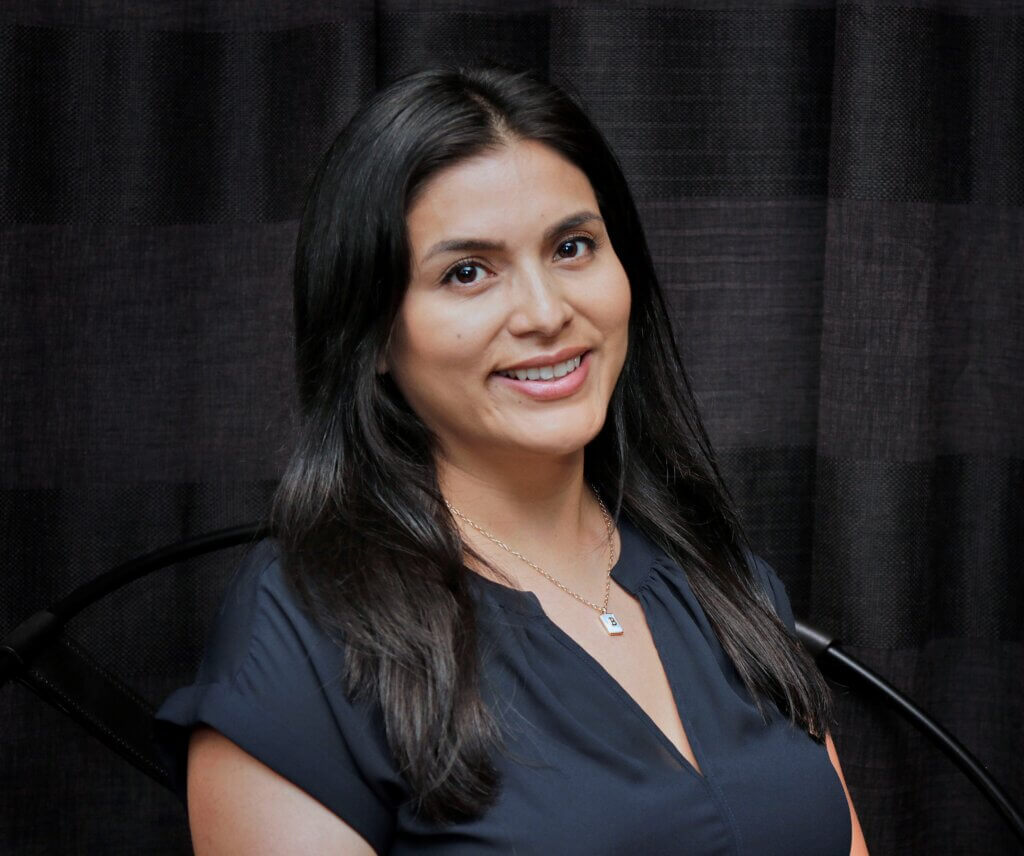 A smiling woman with long, black hair