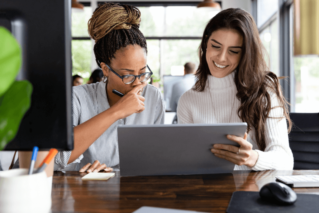 Two professionals collaborating on a tablet