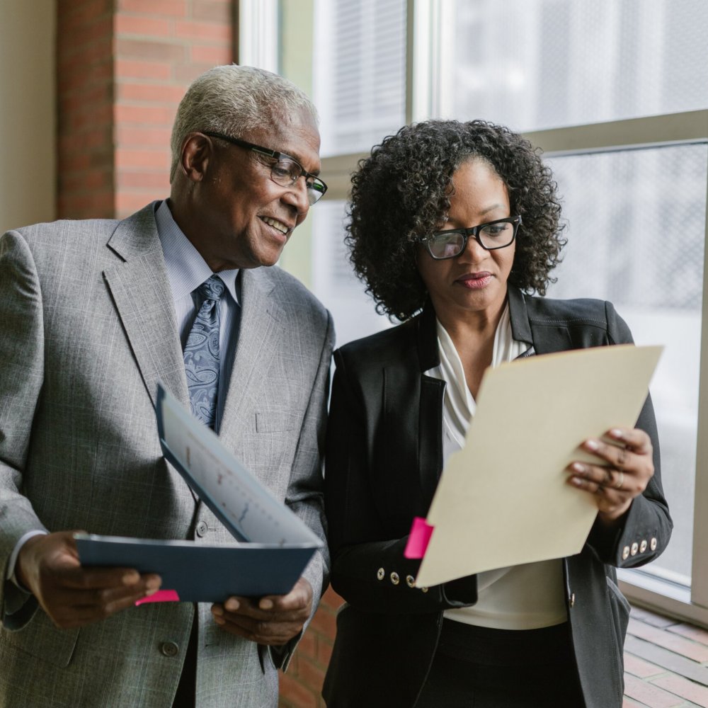 pexels-rdne-stock-project-8124247 Two businesspeople looking over documents together